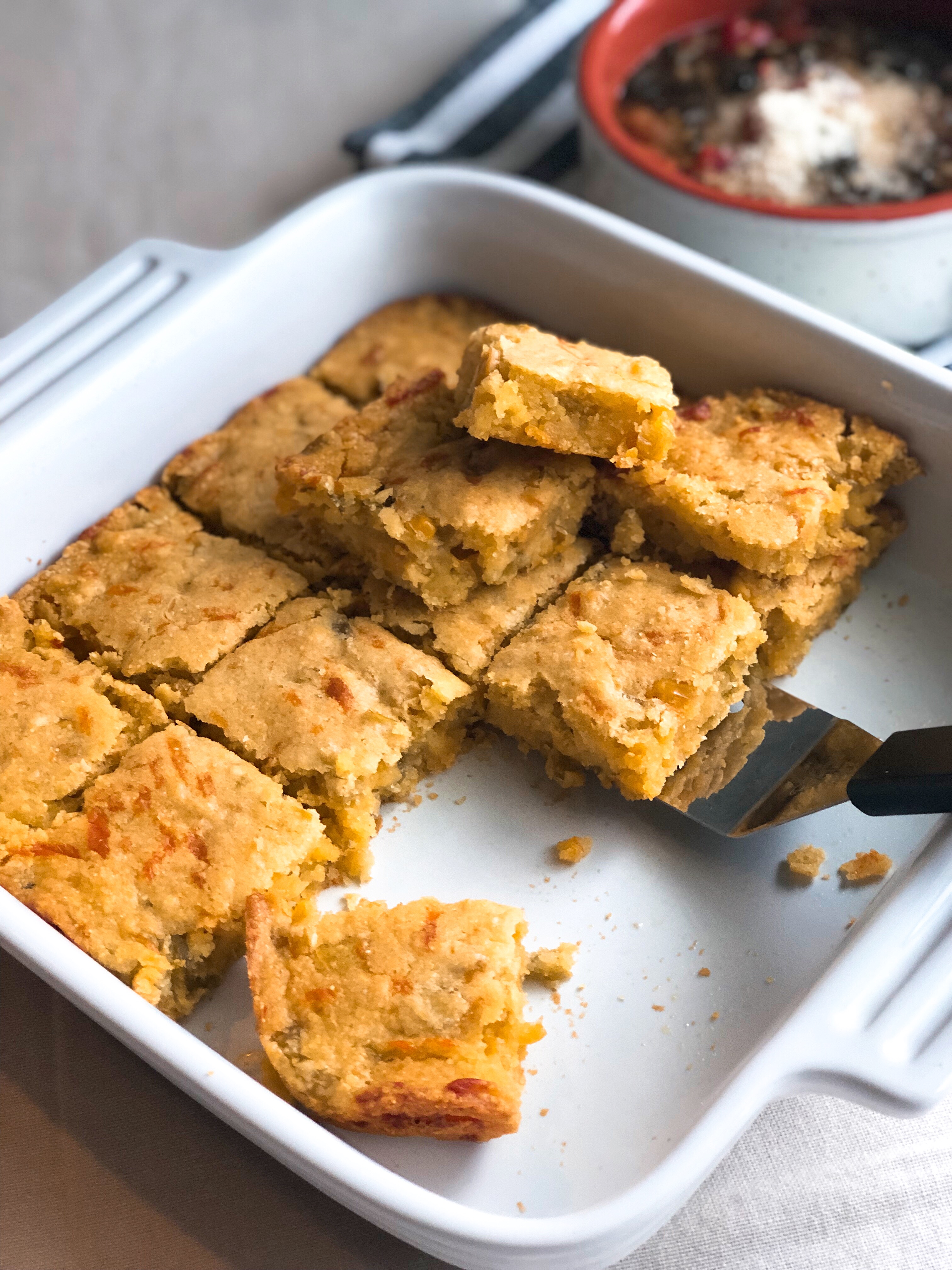 Green Chili Cornbread in a white square baking dish