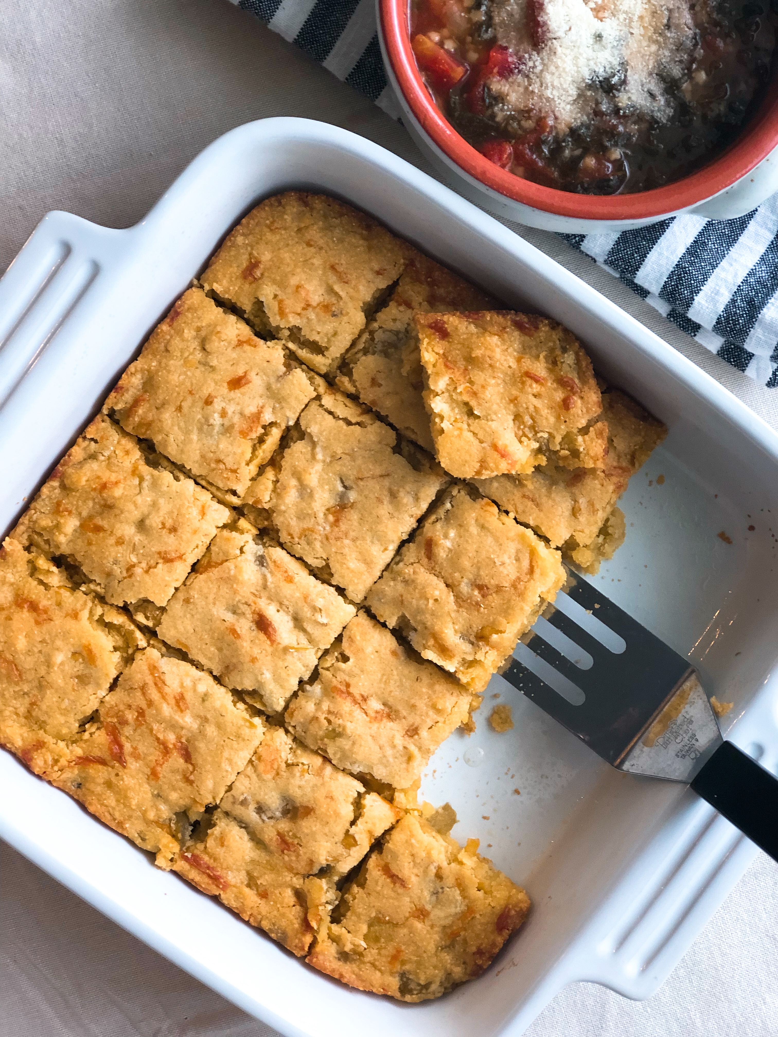 Green Chili Cornbread in a white square baking dish