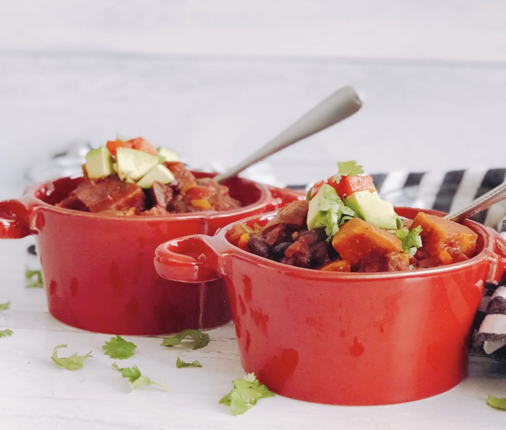 Vegetarian Sweet Potato Chili in red bowls with spoon.