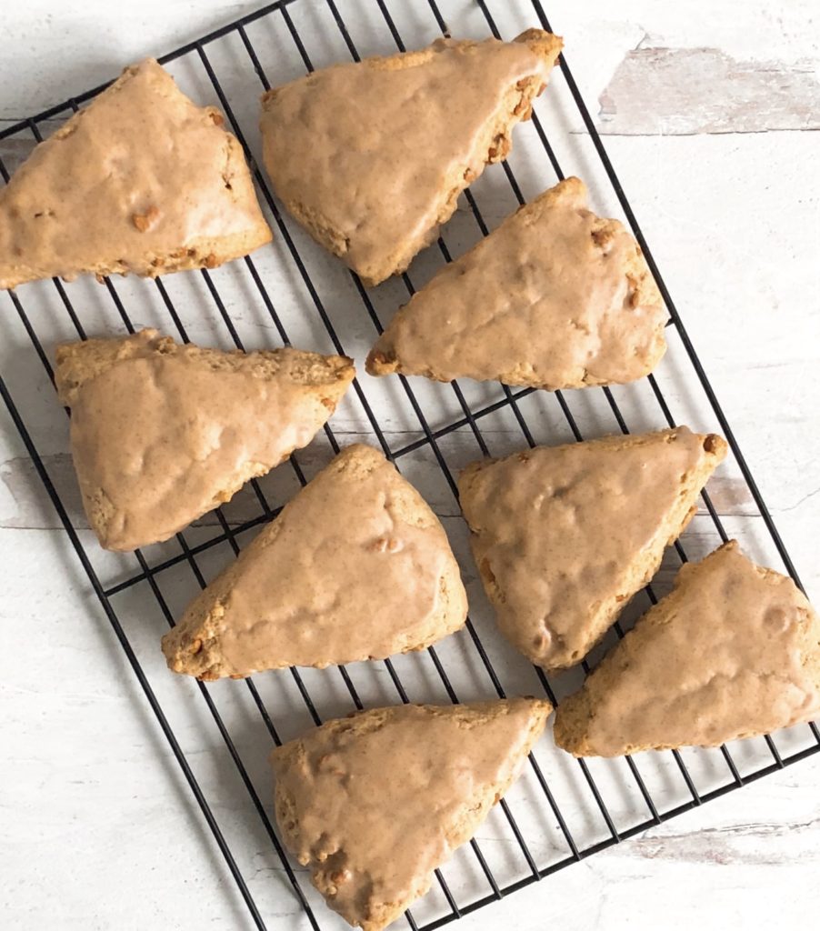 Cinnamon Chip Scones arranged on a black wire cooling rack