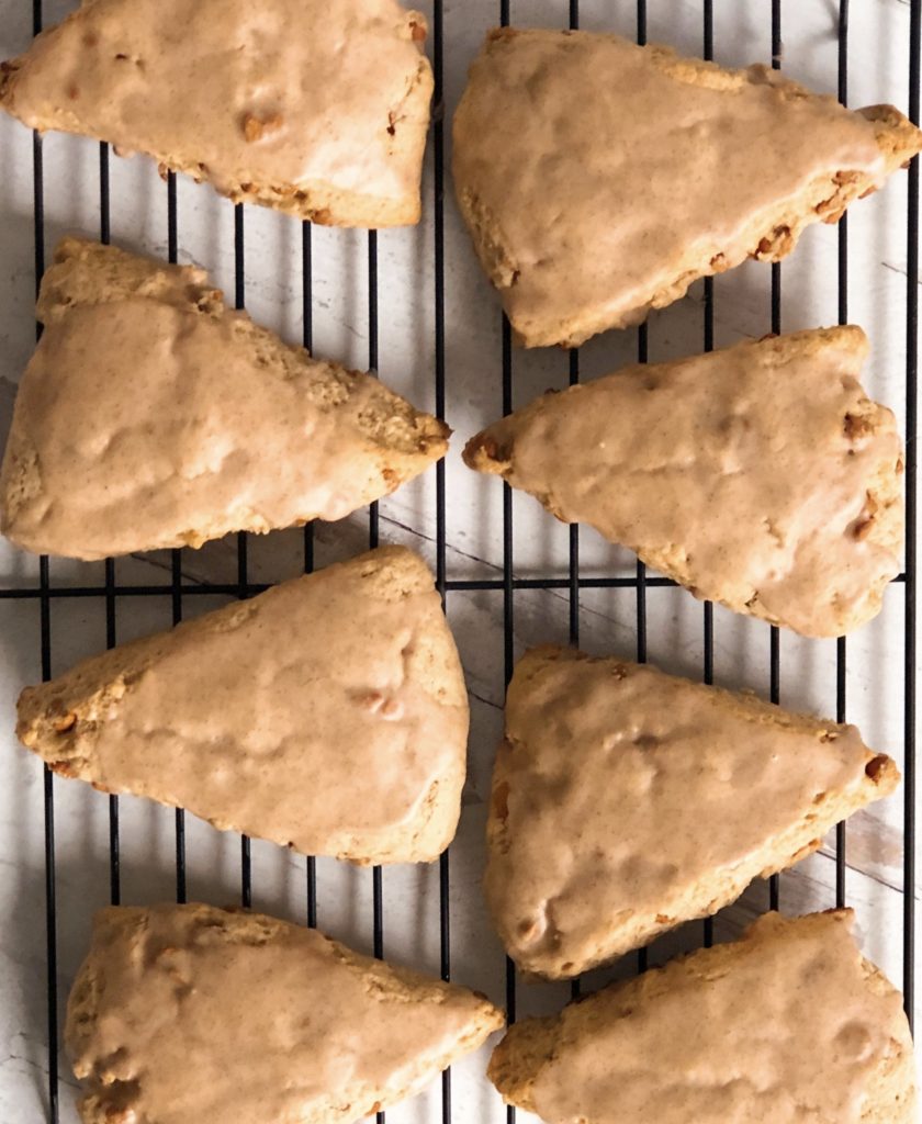 Cinnamon Chip Scones arranged on a black wire cooling rack