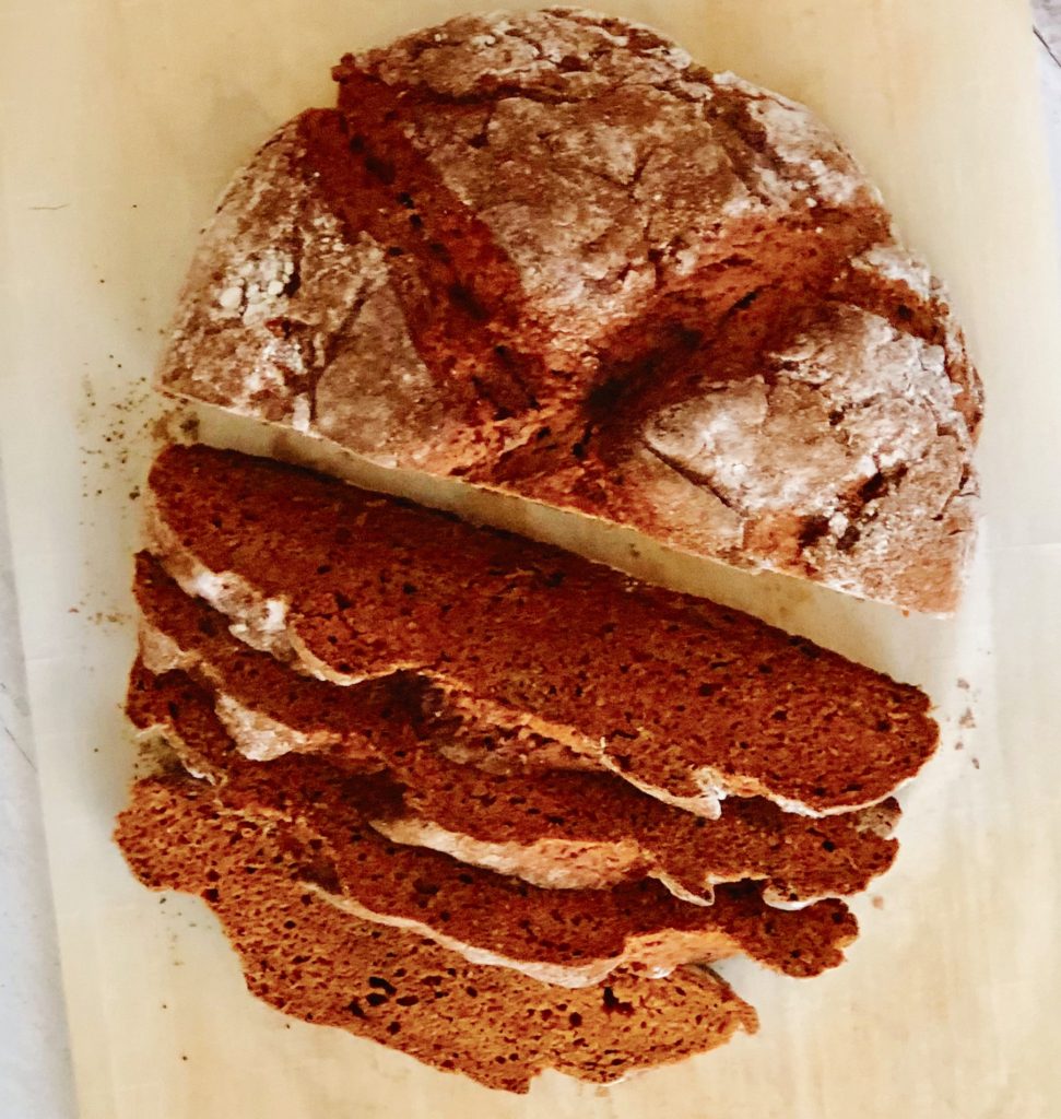 Pumpkin Spice Soda Bread sliced on a piece of parchment.