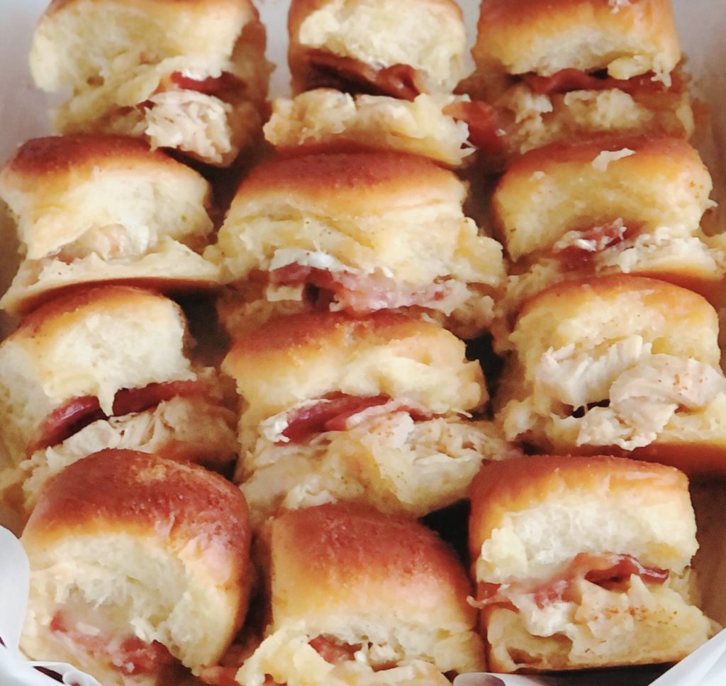 Rows of melty Turkey Bacon Brie Sliders in a pan.
