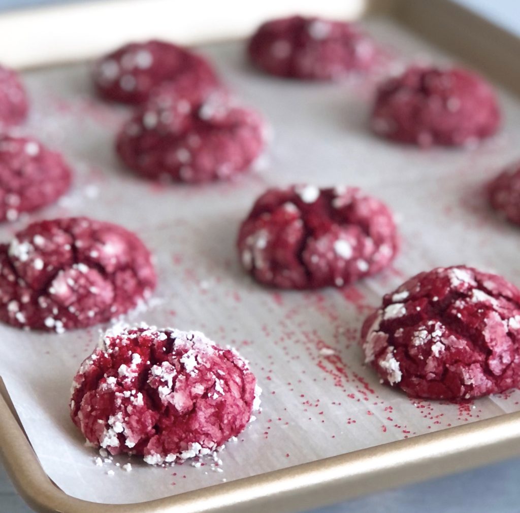 Red Velvet Gooey Butter Cookies on a cookie sheet.