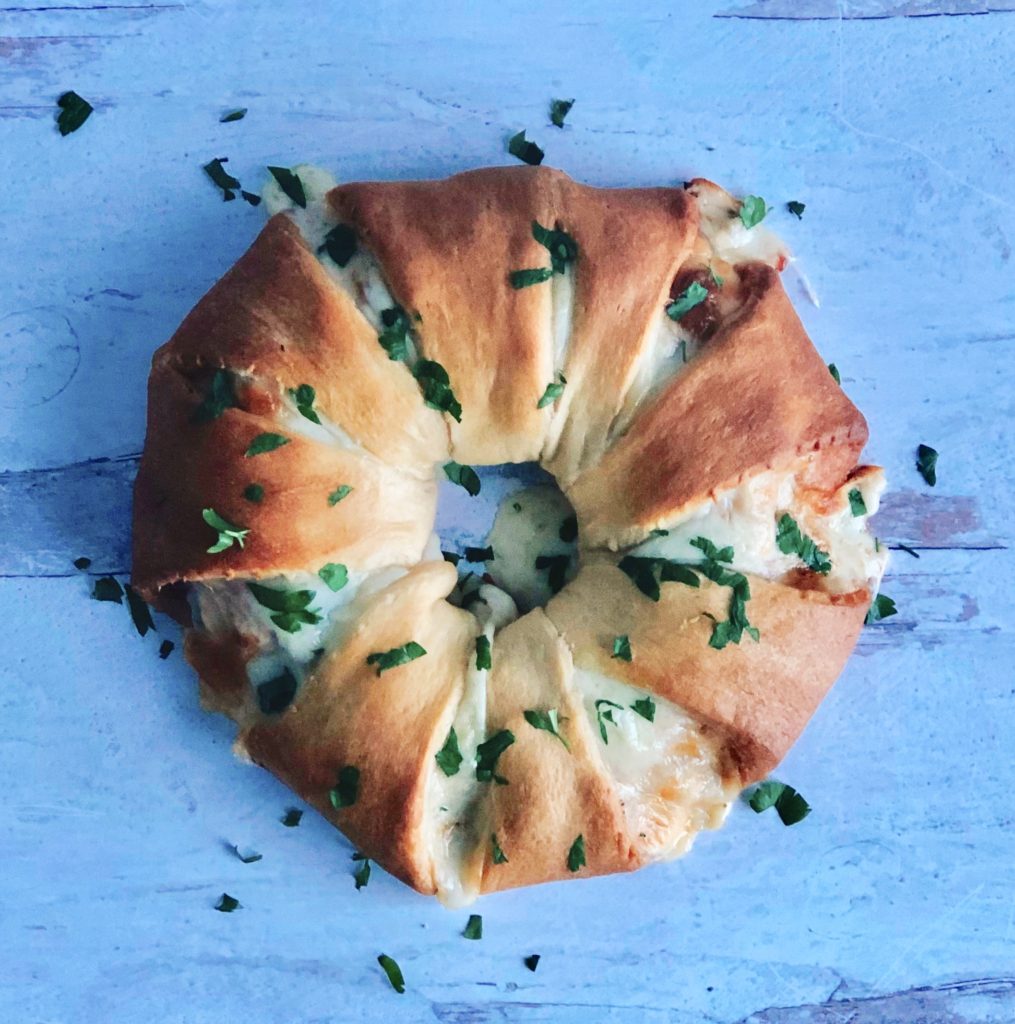 Italian Sub Sandwich Ring sprinkled with parsley.