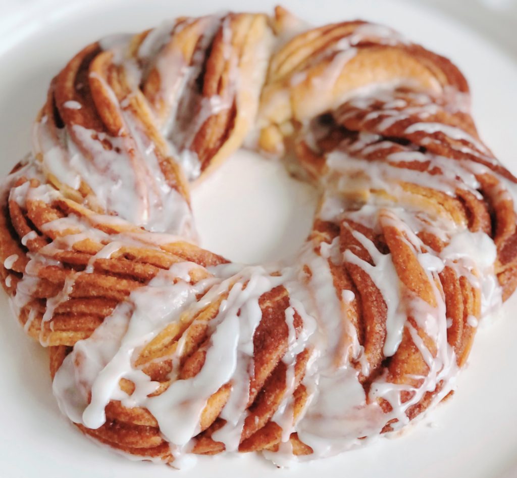 Cinnamon Roll Crescent Wreath with icing drizzled over top.