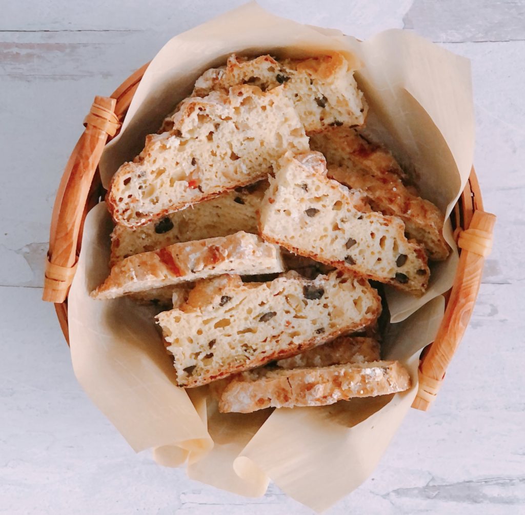 Mozzarella and Olive Soda Bread sliced in a bread basket.