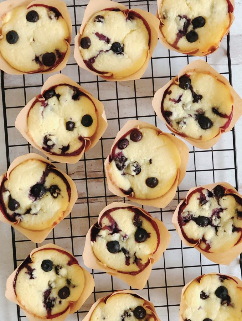 Blueberry Ricotta Muffins on a wire cooling rack 