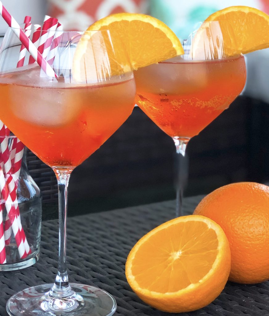 Aperol Spritz in Wine Glasses with straws