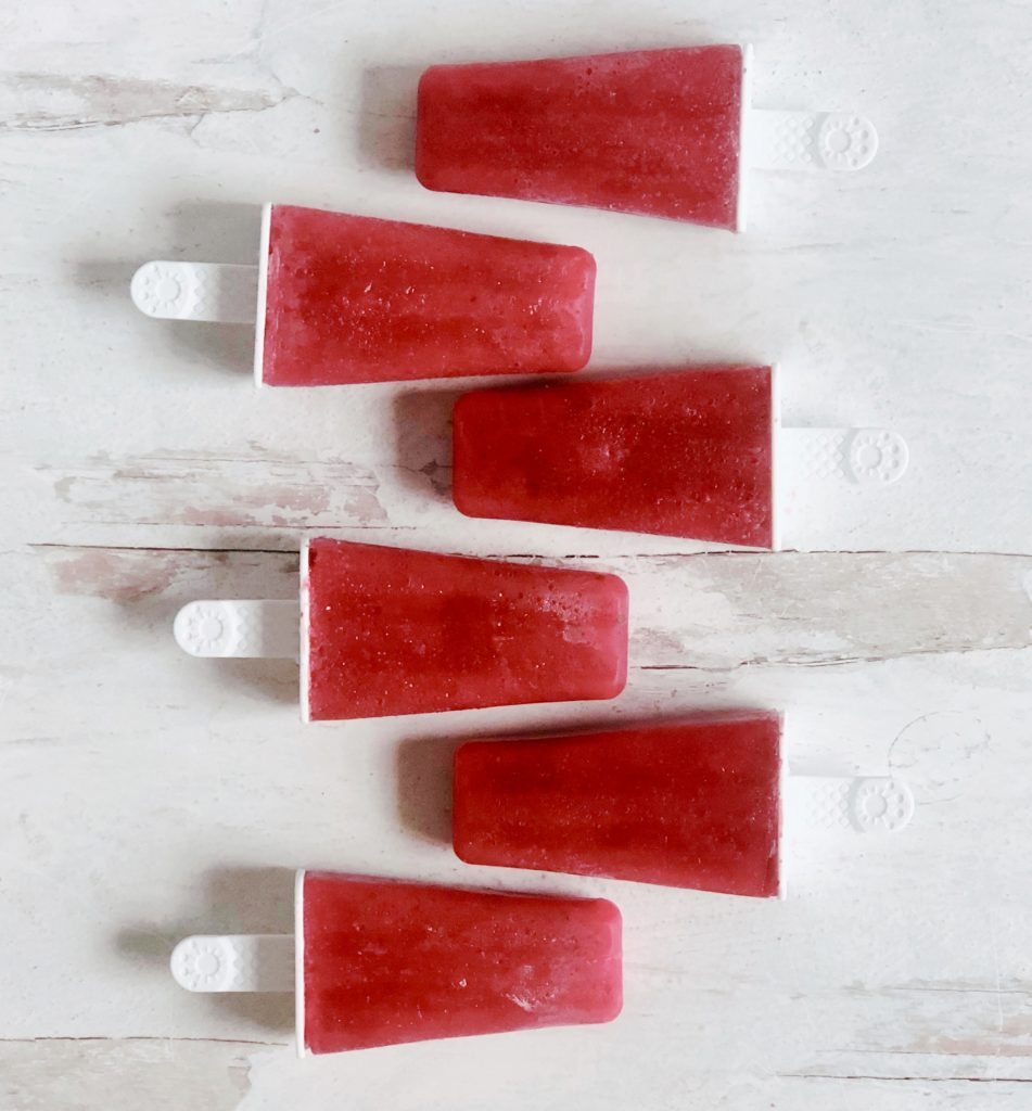 Strawberry Basil Popsicles laying side by side