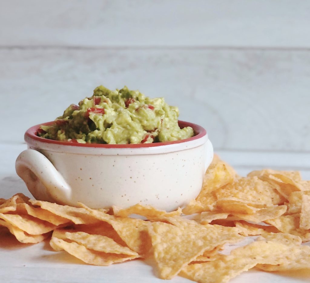Easy Guacamole in a bowl surrounded by tortilla chips