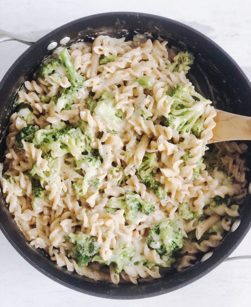 One Pot Broccoli Alfredo in pan with wooden spoon