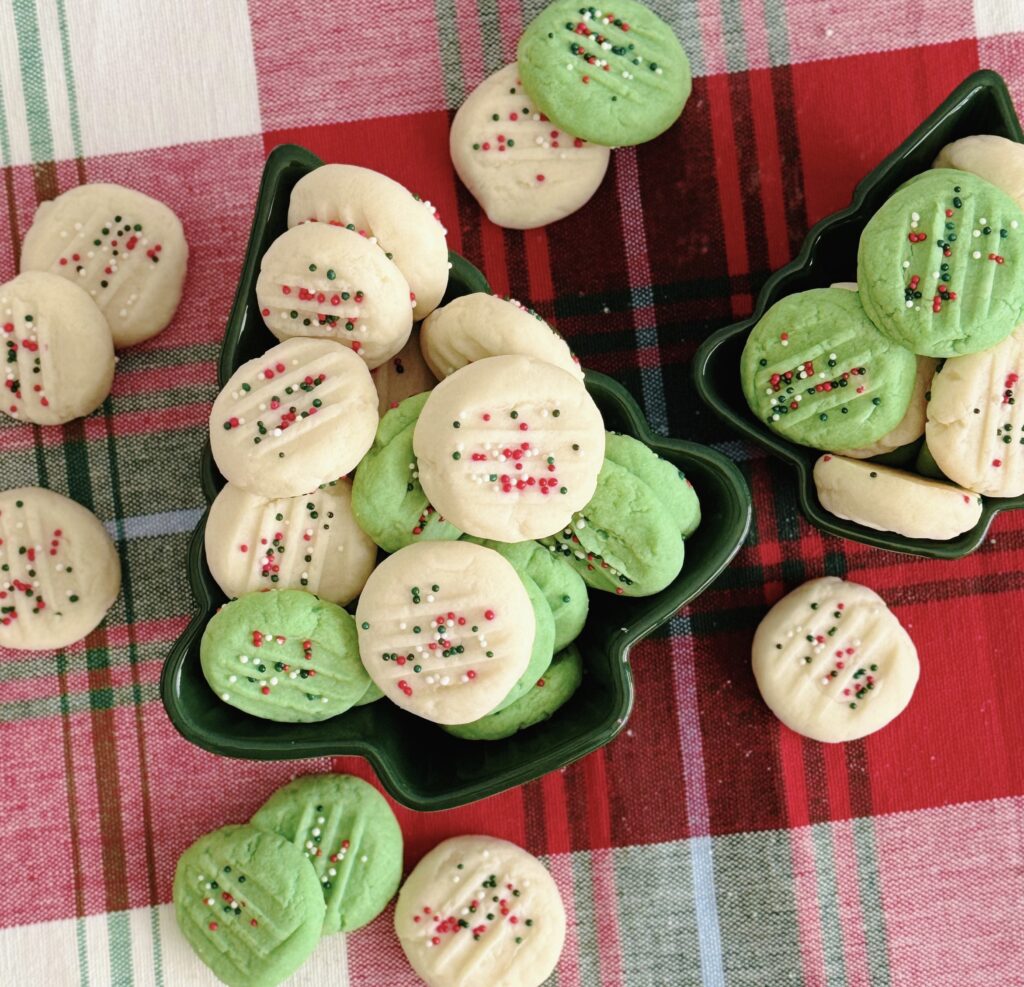 Whipped Shortbread Cookies in green Christmas tree bowls.