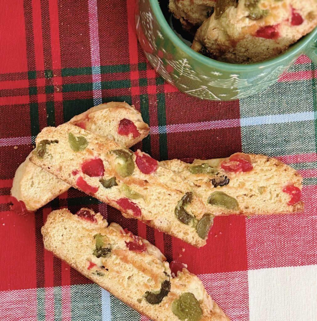 Candied Cherry Biscotti on a red and green plaid table runner